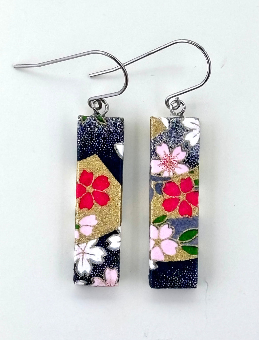 Pair of floral patterned earrings on a white background